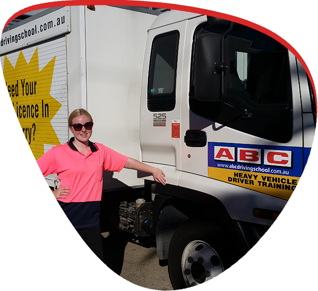 women next to abc driving school truck